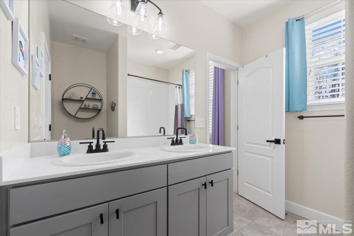 2711 McCauley Ranch Boulevard Reno, NV 89521 - Photo 28 of 40 a bathroom with a sink double vanity and a mirror