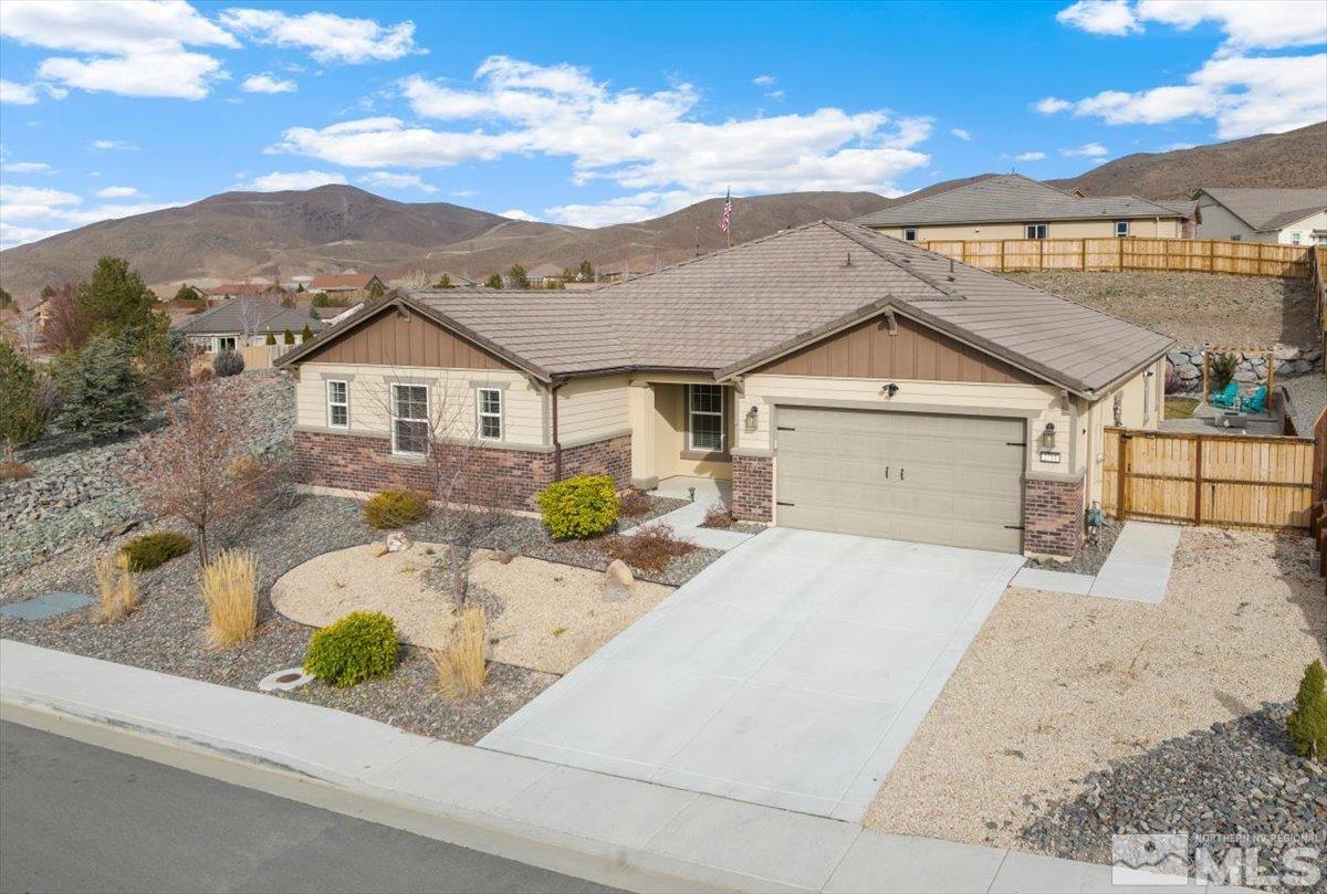 2711 McCauley Ranch Boulevard Reno, NV 89521 - Photo 3 of 40 a front view of a house with a garden and mountain view