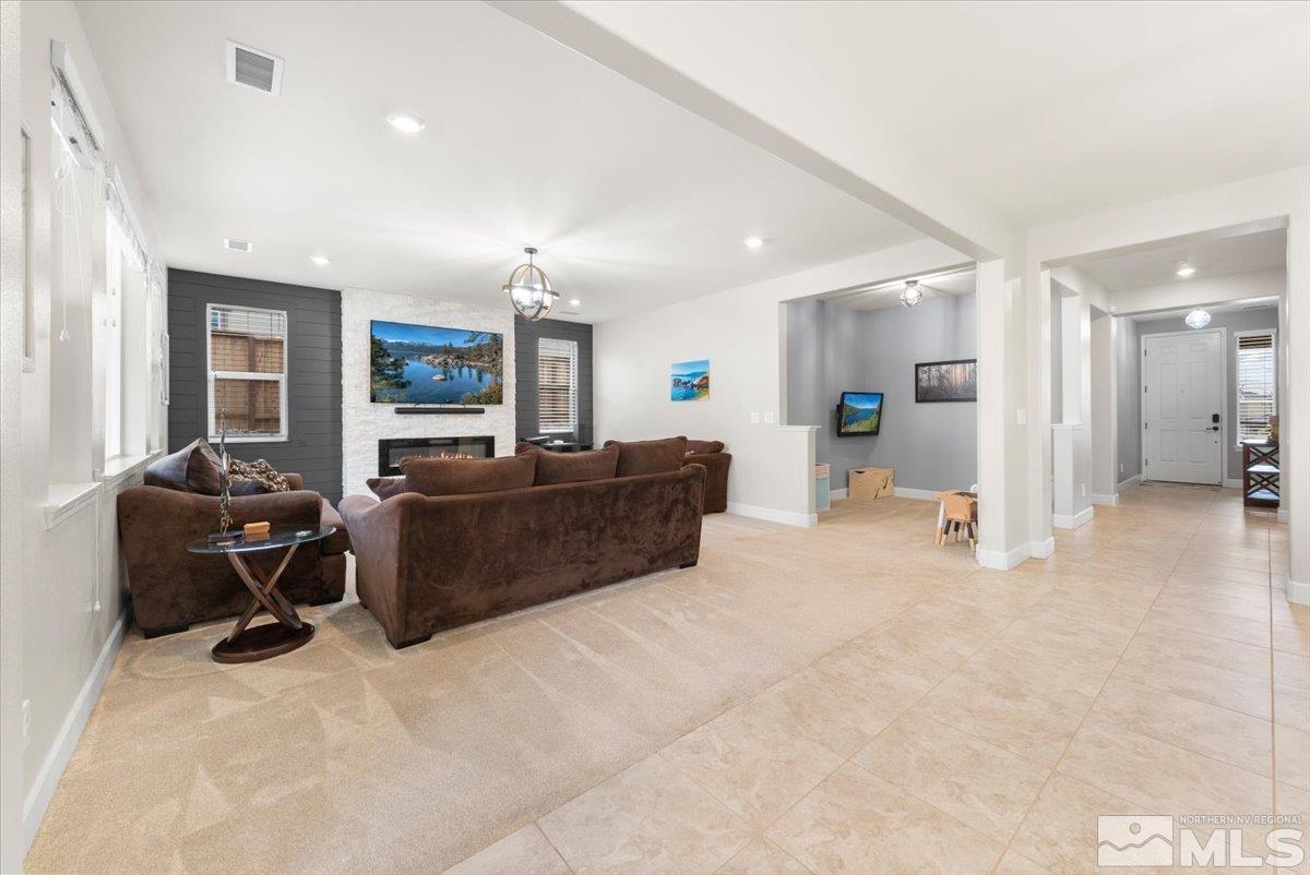 2711 McCauley Ranch Boulevard Reno, NV 89521 - Photo 5 of 40 a living room with furniture a couch and a flat screen tv