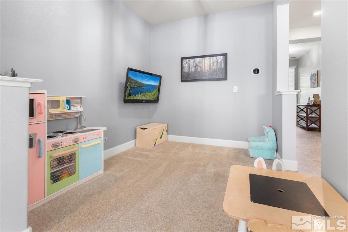 2711 McCauley Ranch Boulevard Reno, NV 89521 - Photo 8 of 40 a room with furniture and a flat screen tv