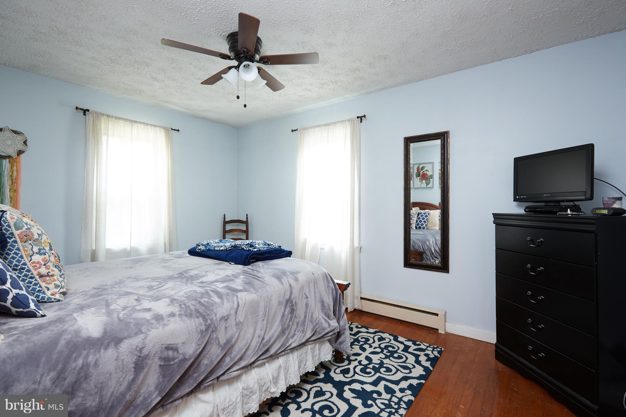 4910 Old Swimming Pool Road Frederick, MD 21703 - Photo 11 of 26 a bedroom with a bed and a tv