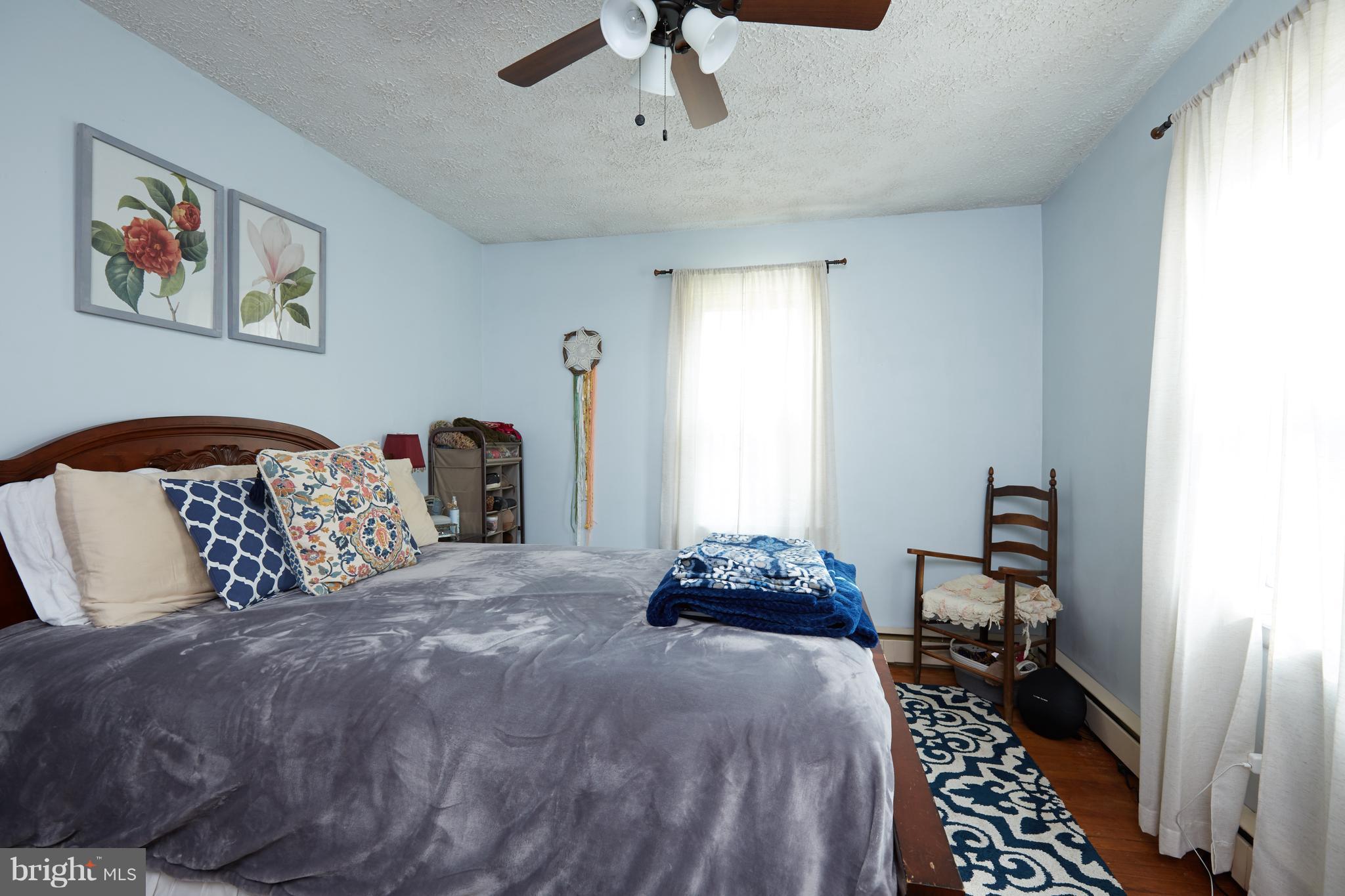 4910 Old Swimming Pool Road Frederick, MD 21703 - Photo 12 of 26 a bedroom with a bed and a chandelier