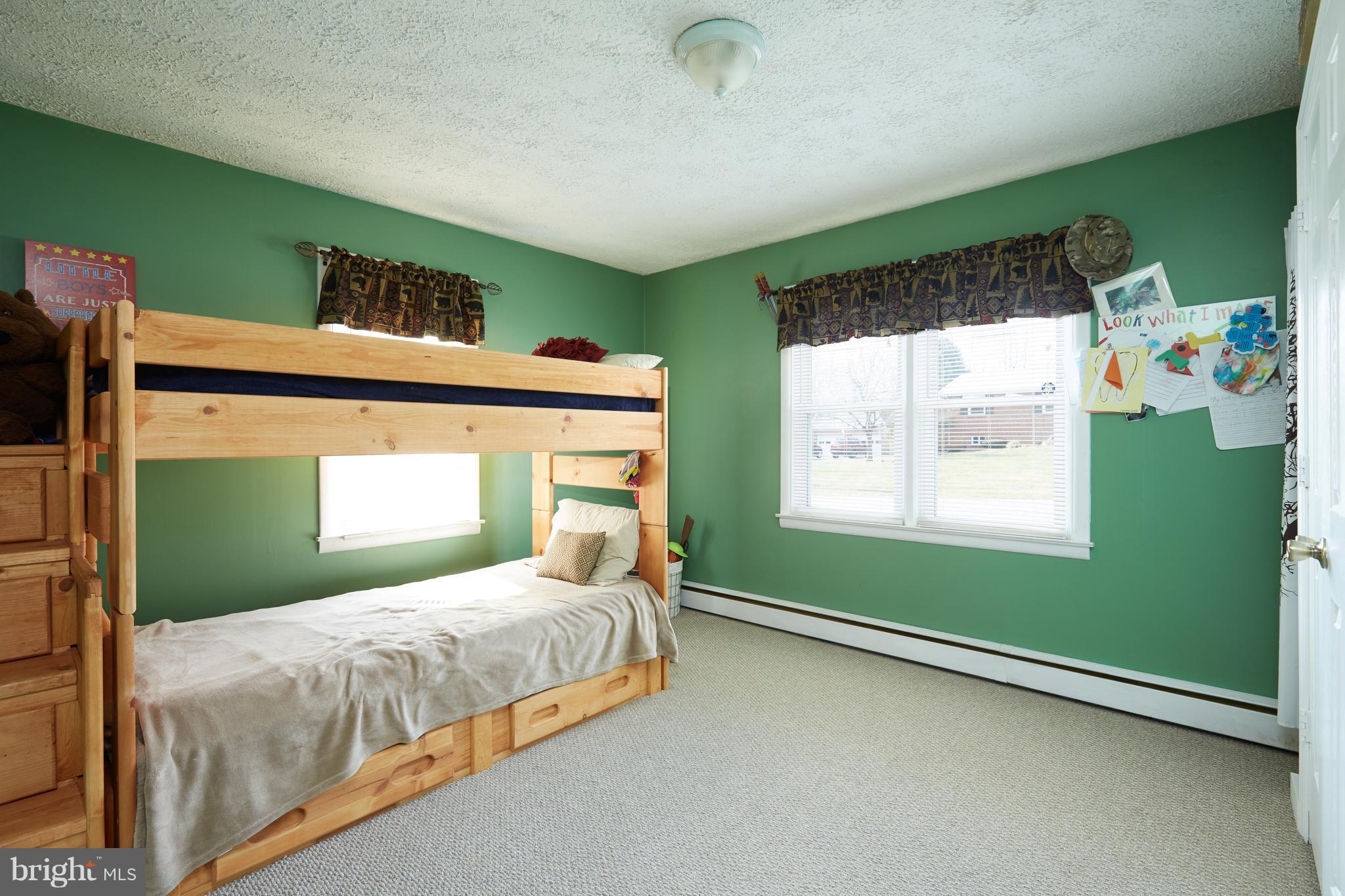 4910 Old Swimming Pool Road Frederick, MD 21703 - Photo 14 of 26 a bedroom with a bed and windows
