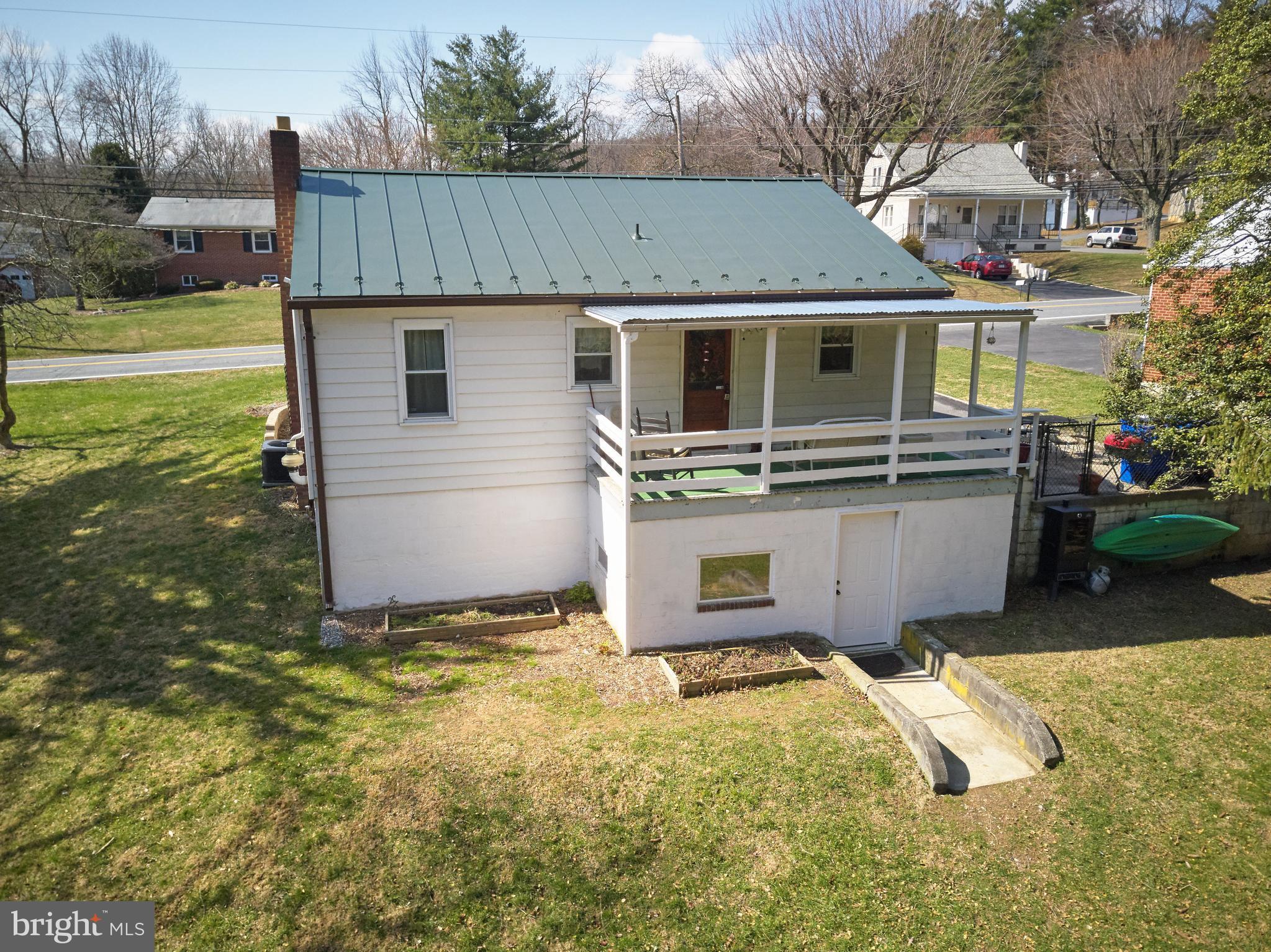 4910 Old Swimming Pool Road Frederick, MD 21703 - Photo 20 of 26 a view of a patio with table and chairs under an umbrella