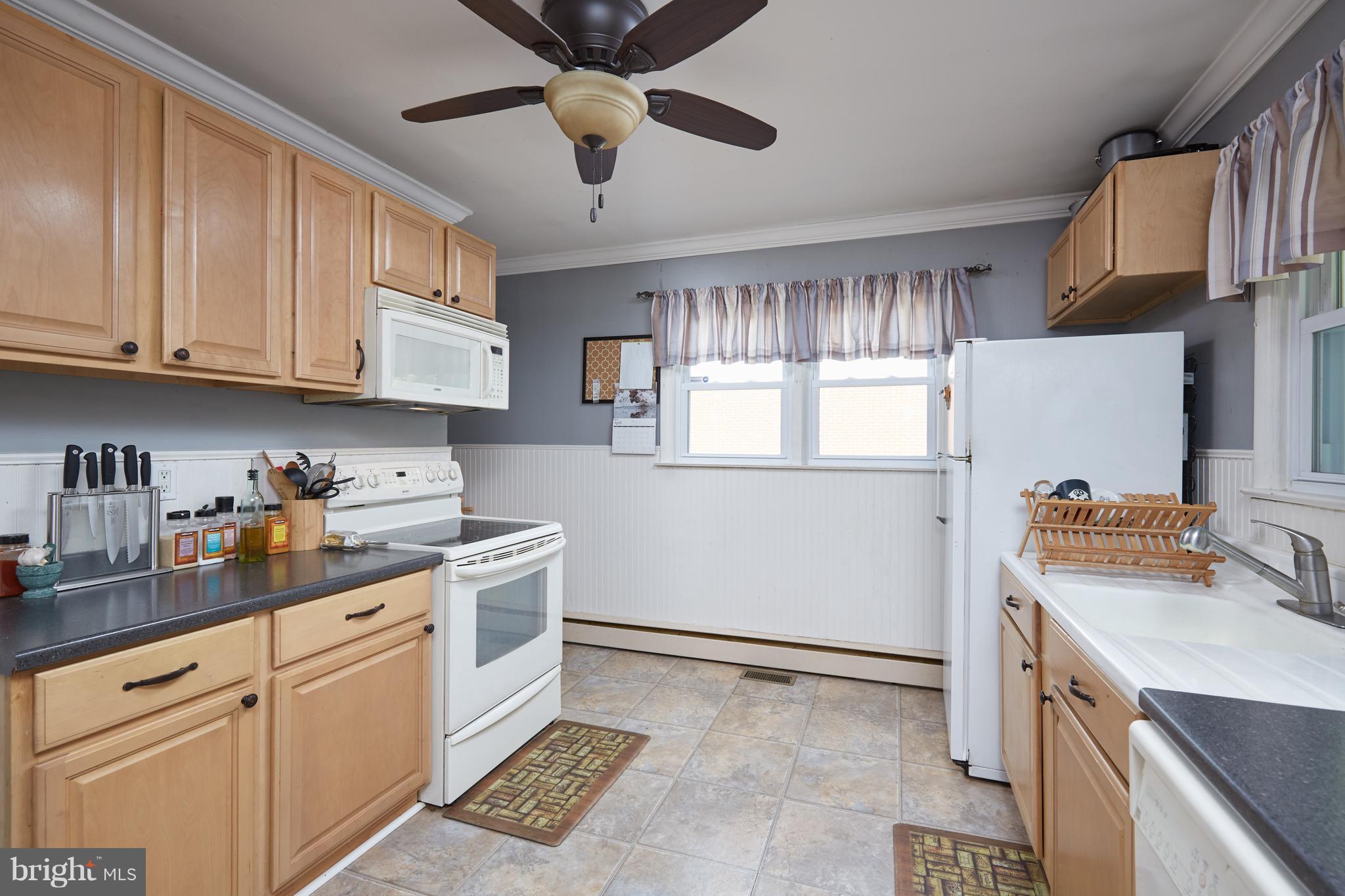 4910 Old Swimming Pool Road Frederick, MD 21703 - Photo 8 of 26 a kitchen with a stove cabinets and a window
