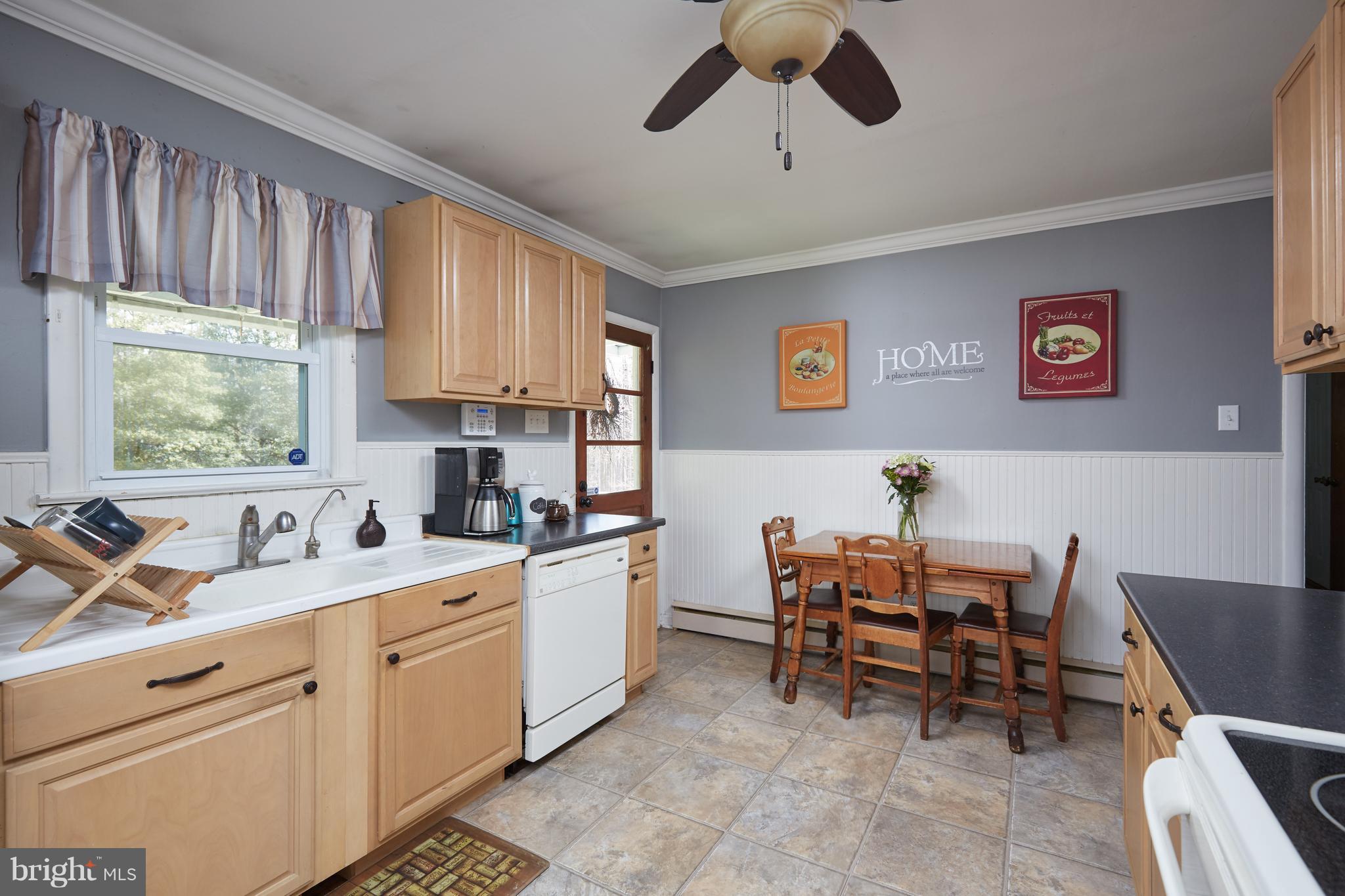 4910 Old Swimming Pool Road Frederick, MD 21703 - Photo 9 of 26 a kitchen that has a cabinets counter space dining table and a window