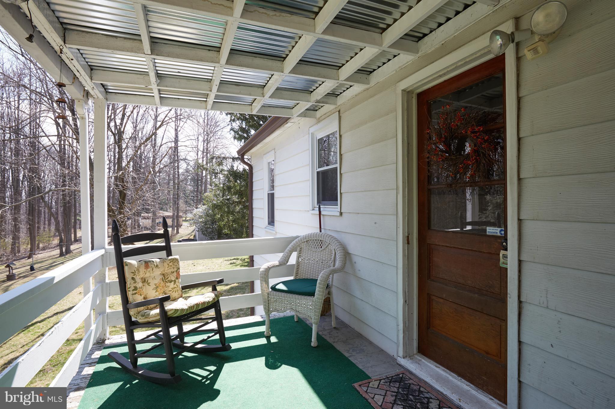 4910 Old Swimming Pool Road Frederick, MD 21703 - Photo 10 of 26 a view of a porch with furniture and a gate