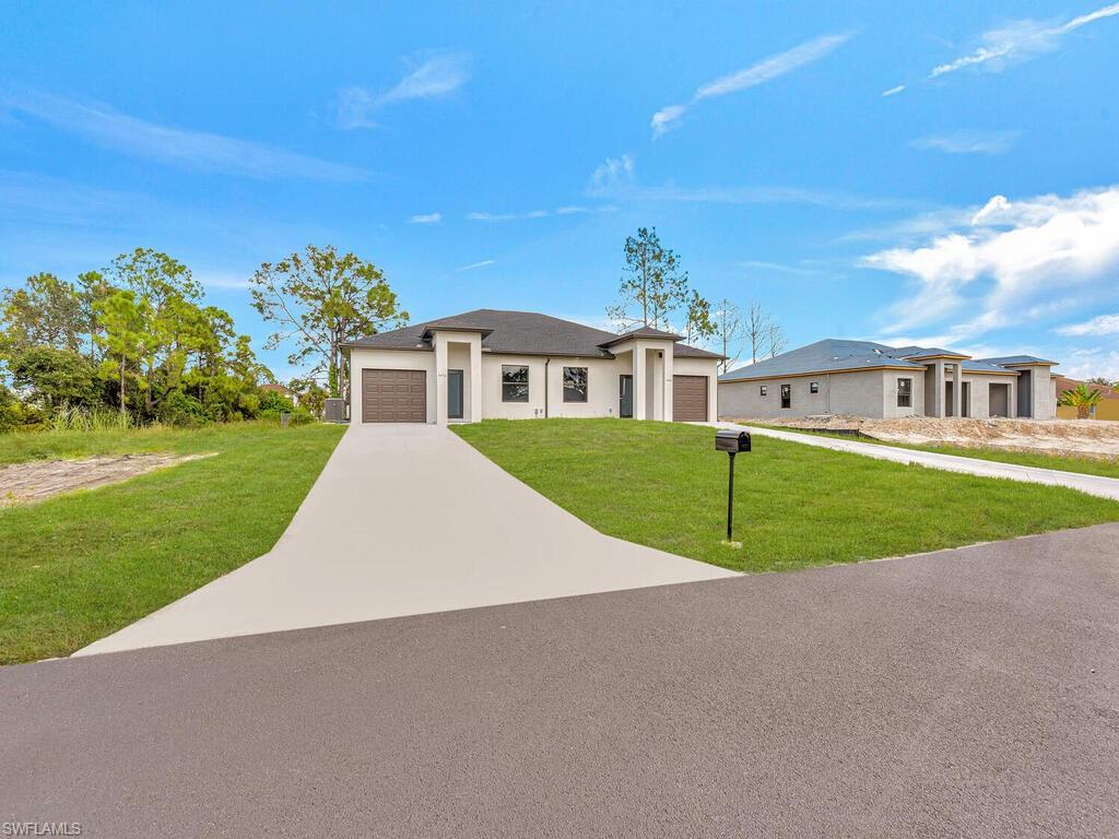 4450-4452 24th Street Southwest Lehigh Acres, FL 33973 - Photo 26 of 49 a view of a house with a big yard