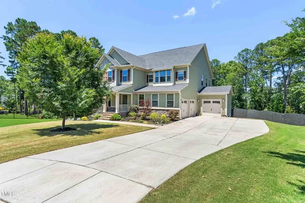 a front view of house with yard and green space