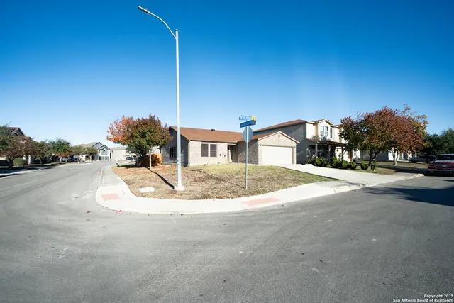 a living room with furniture wooden floor and a large window
