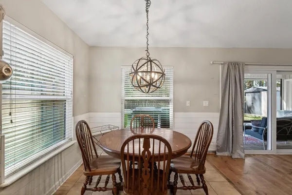 a view of a dining room with furniture window and wooden floor