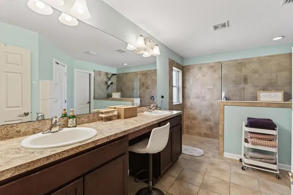 a bathroom with a granite countertop sink a toilet and a mirror