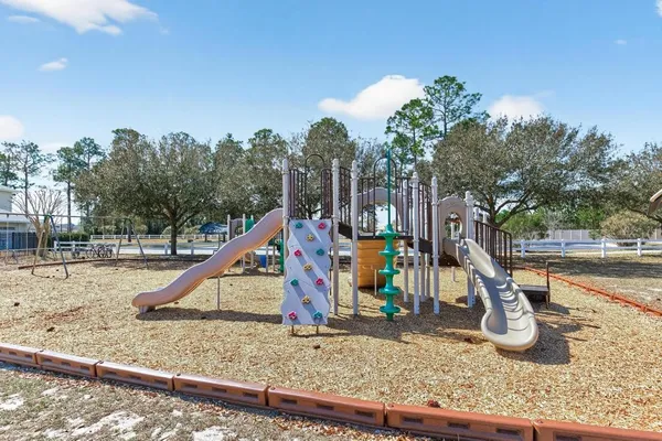 a wooden bench sitting in the middle of a yard
