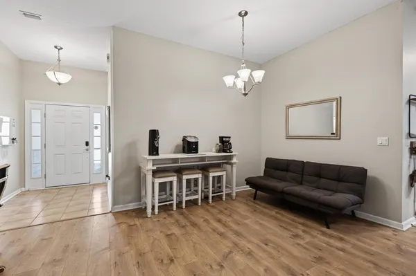 a living room with furniture and a chandelier