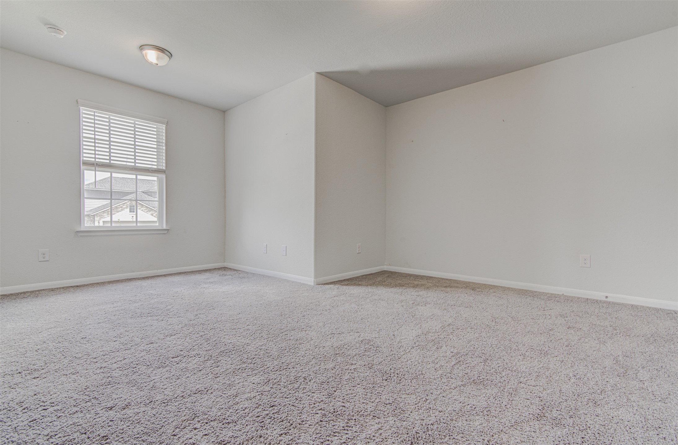 774 Cherrystone Loop Buda, TX 78610 - Photo 26 of 38 A spacious room offers comfortable carpet flooring and natural illumination from a well-placed window.