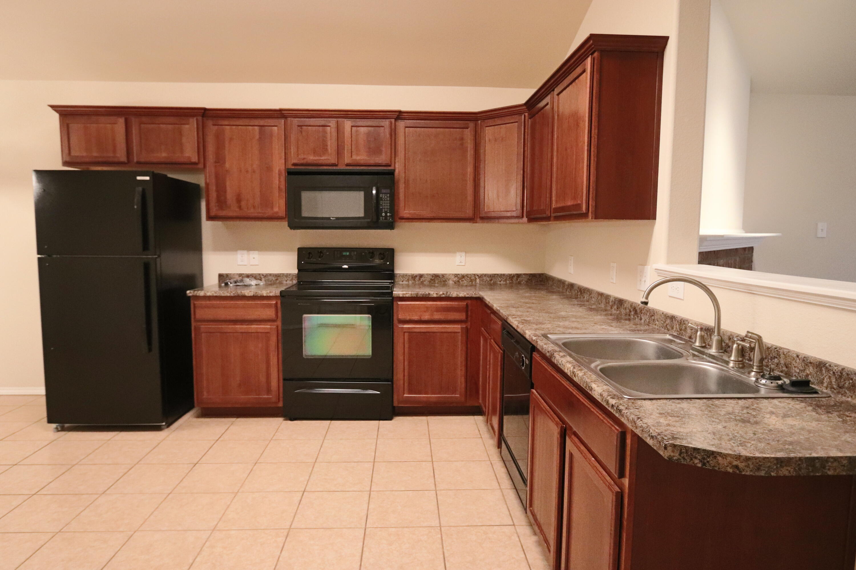 6810 83rd Street Lubbock, TX 79424 - Photo 4 of 9 a kitchen with a sink a stove and refrigerator