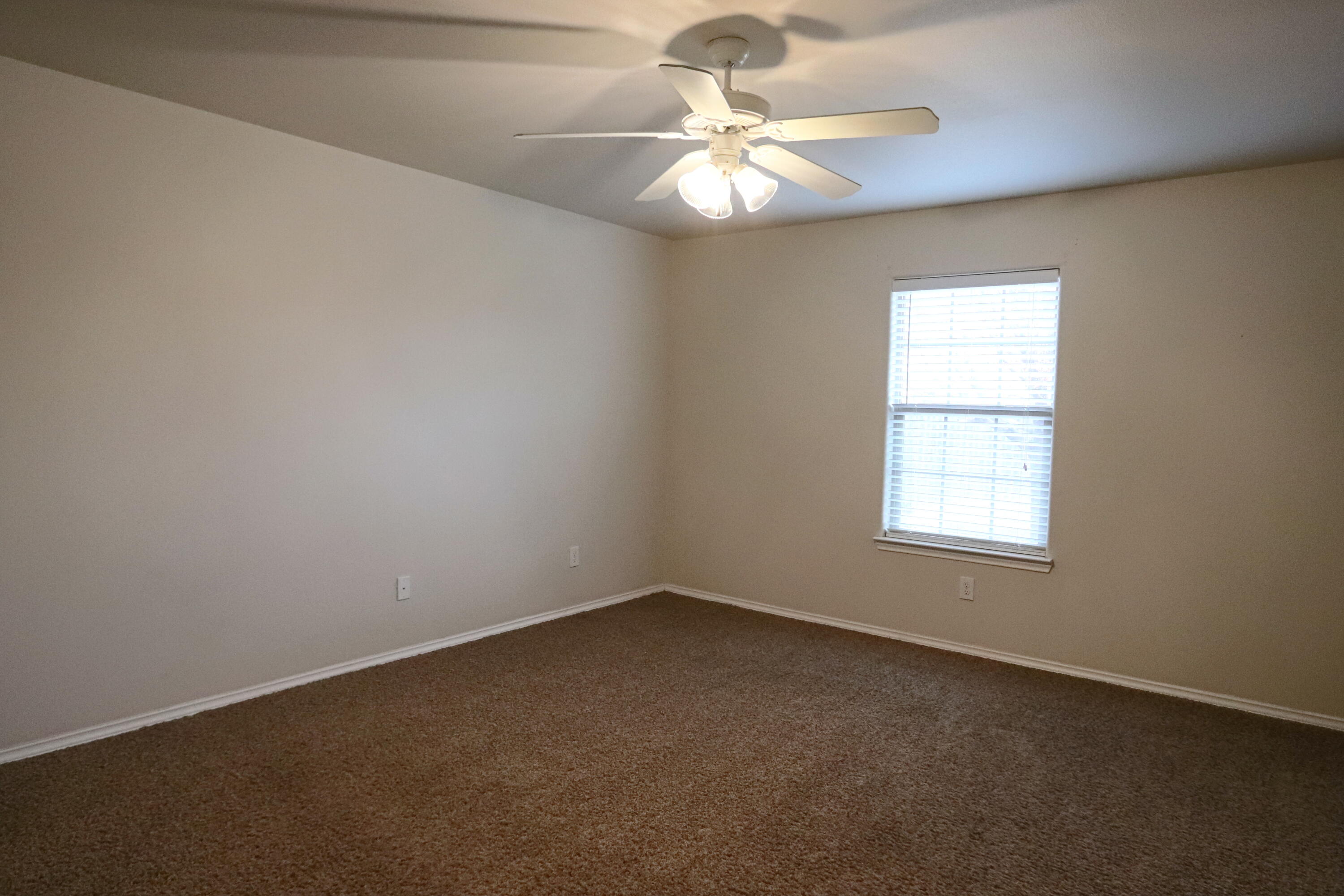 6810 83rd Street Lubbock, TX 79424 - Photo 6 of 9 an empty room with a window