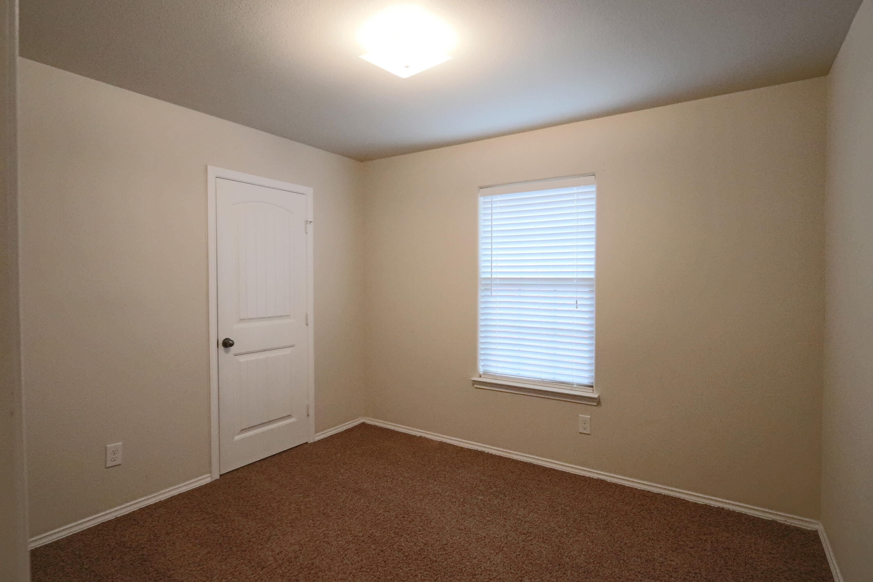 6810 83rd Street Lubbock, TX 79424 - Photo 8 of 9 an empty room with a window