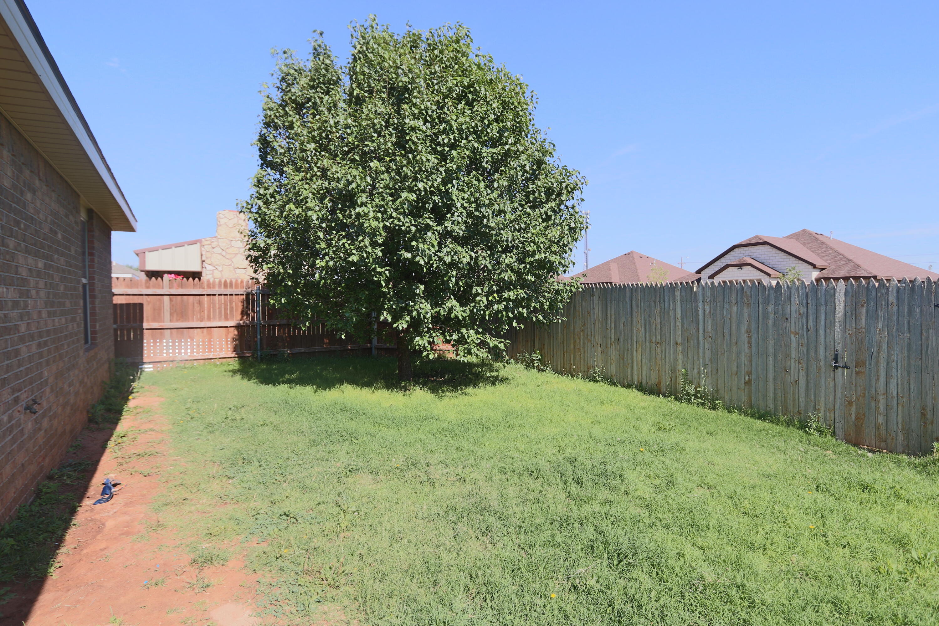 6810 83rd Street Lubbock, TX 79424 - Photo 9 of 9 a backyard of a house with lots of green space