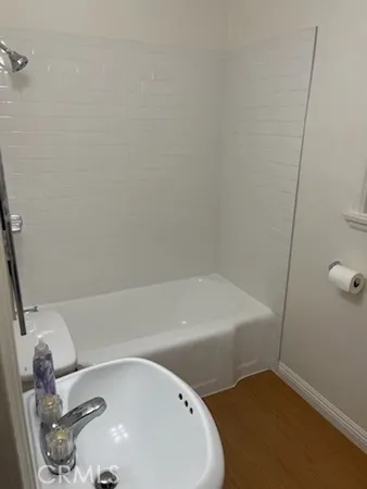 a bathroom with a tub and sink