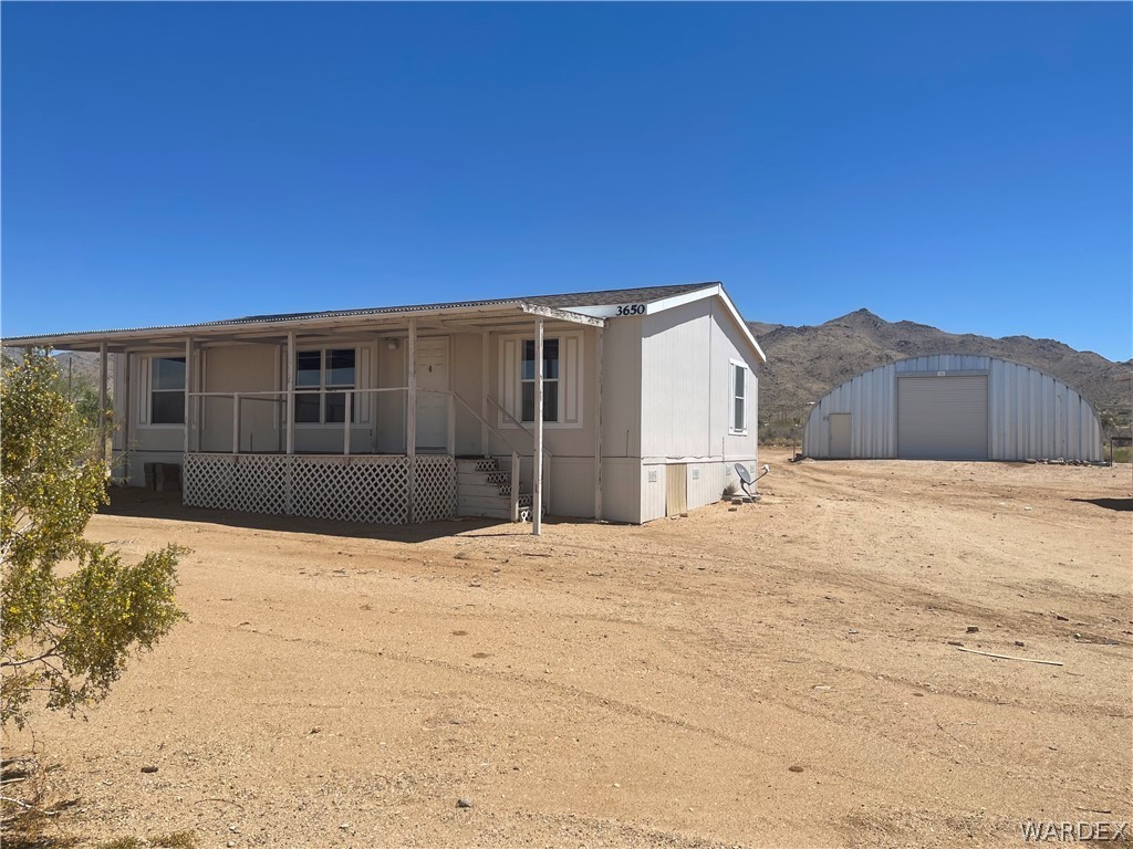 3650 Bosque Road Golden Valley, AZ 86413 - Photo 8 of 34 a view of house with a yard