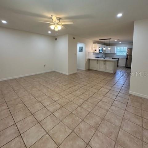525 South Conway Road, Unit 51 Orlando, FL 32807 - Photo 3 of 18 a view of kitchen and hallway with chandelier