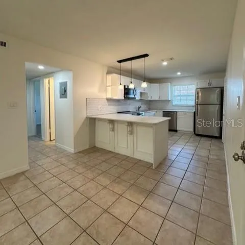 a kitchen with stainless steel appliances a sink and cabinets
