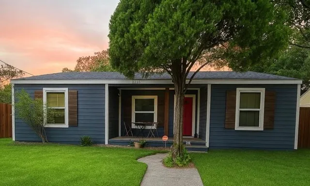 a front view of a house with a garden