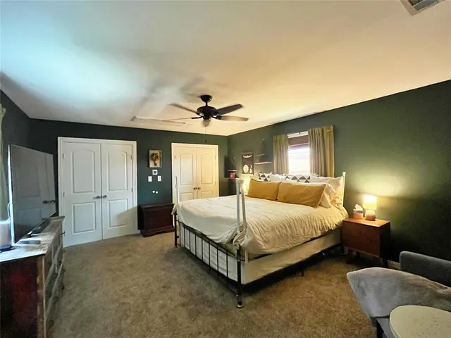 a spacious bedroom with a bed and a couch