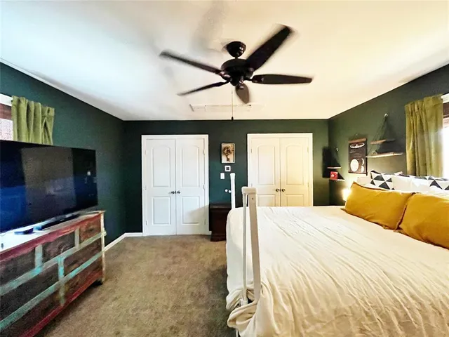 a bedroom with a bed and flat screen tv