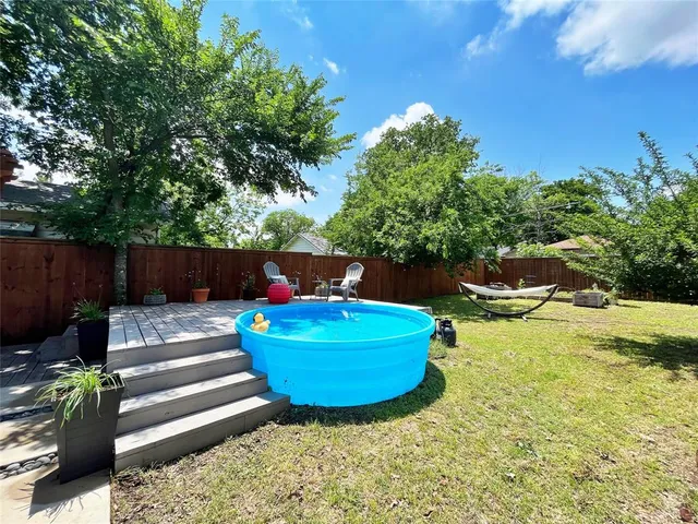 a view of a backyard with sitting area