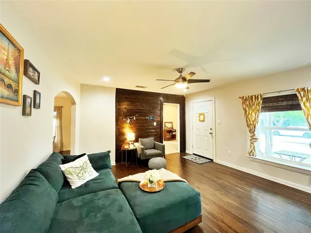 a living room with furniture and wooden floor