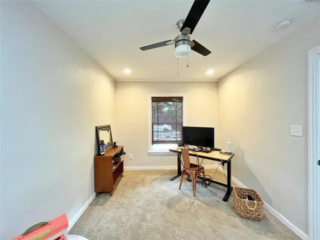 a view of a livingroom with workspace and a window