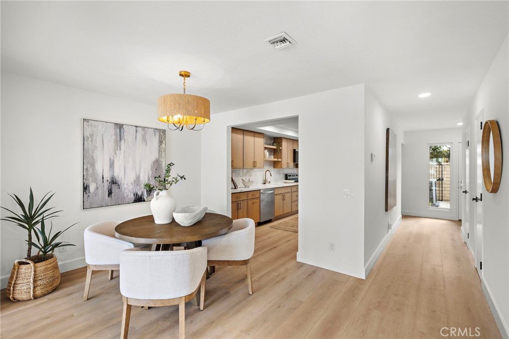 16103 St Croix Circle Huntington Beach, CA 92649 - Photo 20 of 40 a dining room with furniture and chandelier