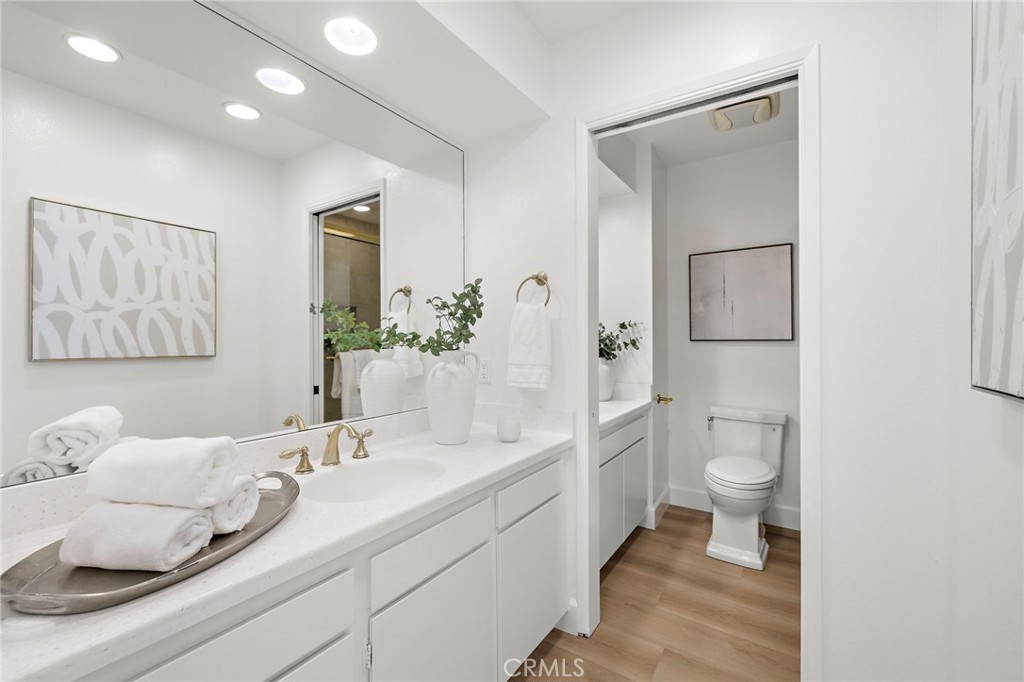 16103 St Croix Circle Huntington Beach, CA 92649 - Photo 29 of 40 a bathroom with a granite countertop sink a toilet and a shower