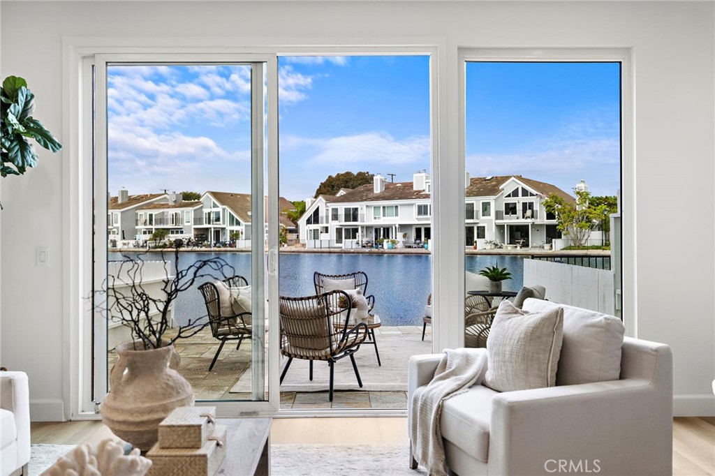 16103 St Croix Circle Huntington Beach, CA 92649 - Photo 3 of 40 a living room with furniture and a floor to ceiling window