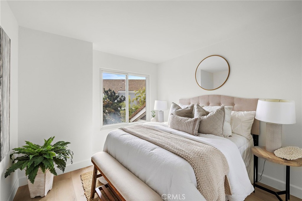 16103 St Croix Circle Huntington Beach, CA 92649 - Photo 31 of 40 a bedroom with bed and a potted plant