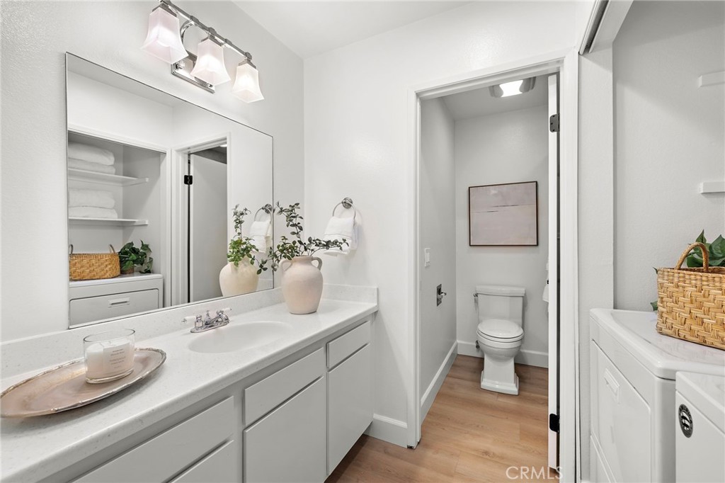 16103 St Croix Circle Huntington Beach, CA 92649 - Photo 33 of 40 a bathroom with a granite countertop sink and a mirror