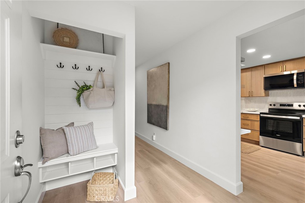 16103 St Croix Circle Huntington Beach, CA 92649 - Photo 10 of 40 a kitchen with granite countertop a refrigerator and a stove top oven
