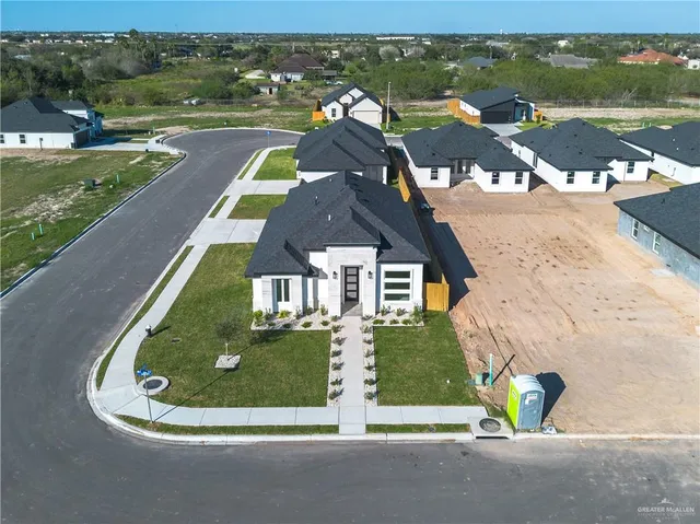 an aerial view of a house with yard swimming pool and outdoor seating