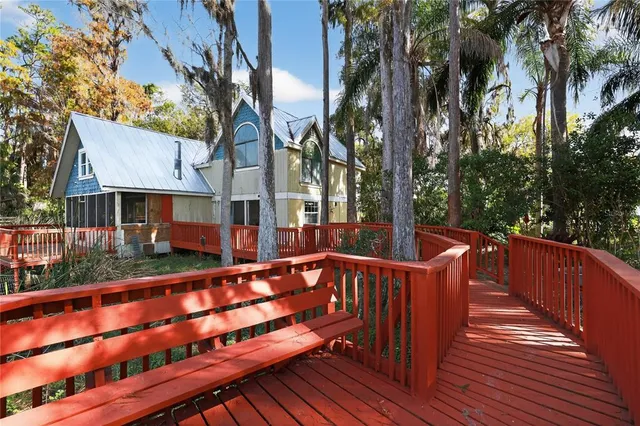 a view of a livingroom with a fireplace window and wooden floor