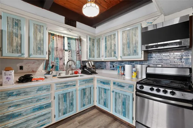 a kitchen with stainless steel appliances granite countertop a refrigerator and a stove
