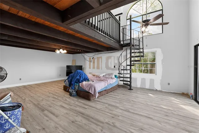 a living room with furniture gym equipment and a large window