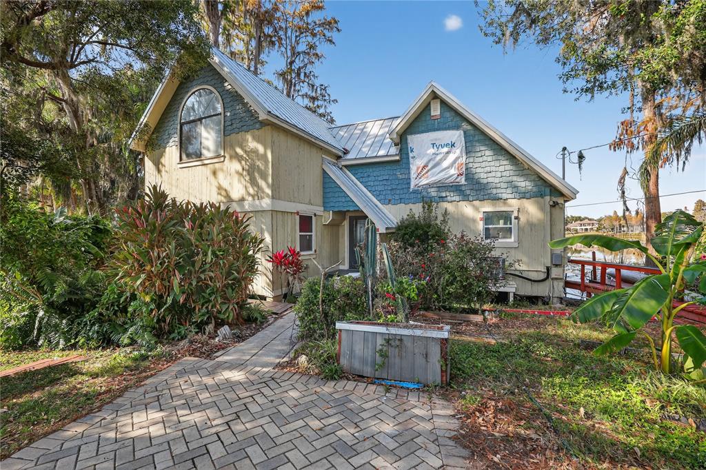8111 North Mobley Road Odessa, FL 33556 - Photo 2 of 42 a front view of a house with garden