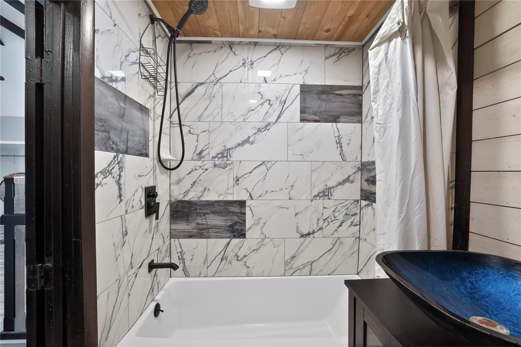 8111 North Mobley Road Odessa, FL 33556 - Photo 23 of 42 a bathroom with a bathtub and shower