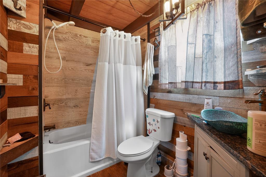 8111 North Mobley Road Odessa, FL 33556 - Photo 25 of 42 a bathroom with a granite countertop sink toilet and shower