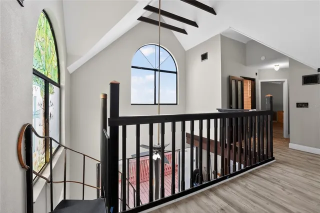 a view of a room with wooden floor and windows