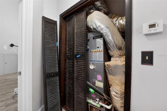 a view of a livingroom with wooden floor and staircase