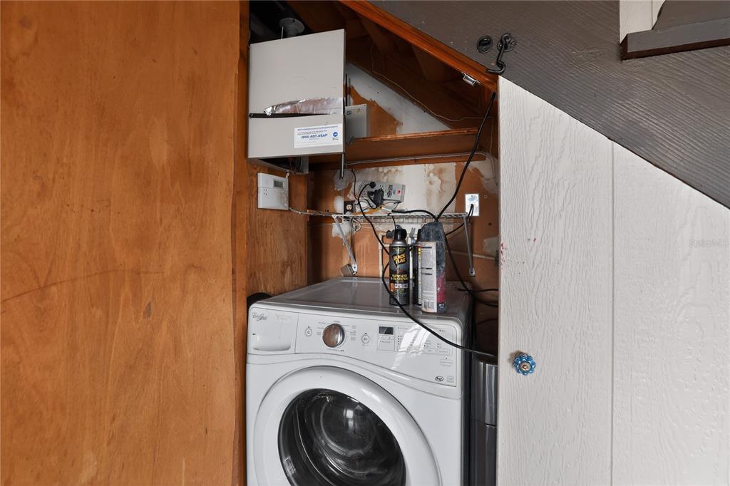8111 North Mobley Road Odessa, FL 33556 - Photo 37 of 42 a view of storage and utility room with washer and dryer
