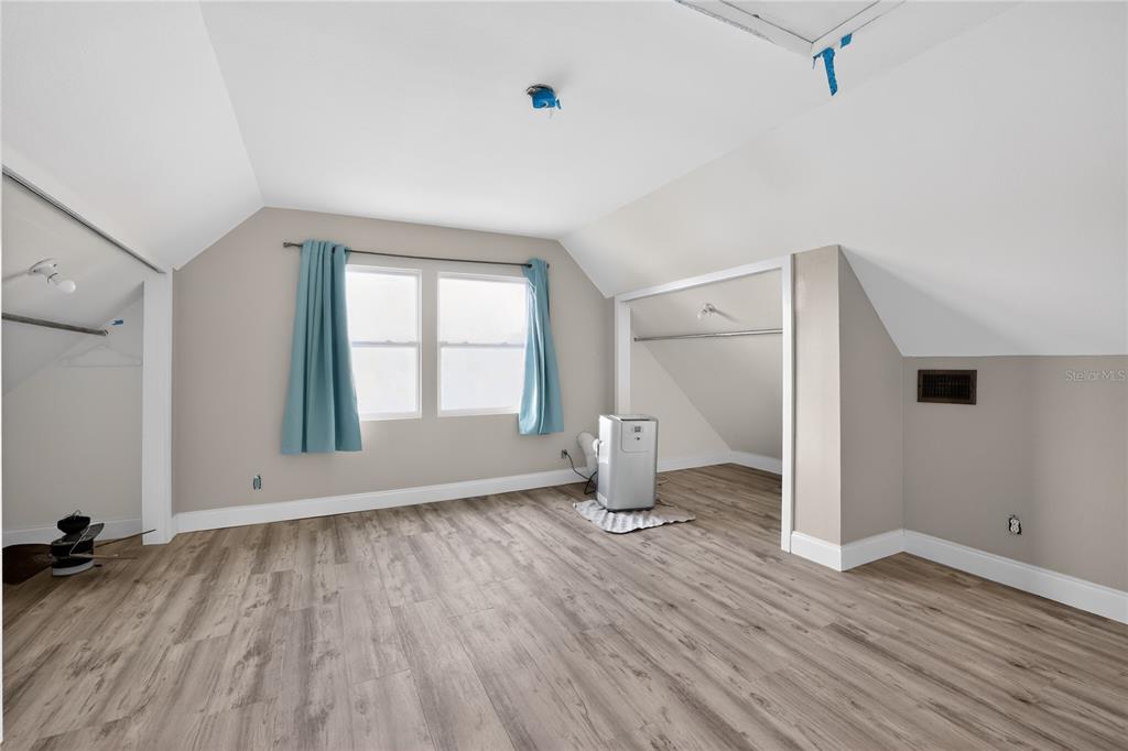 8111 North Mobley Road Odessa, FL 33556 - Photo 38 of 42 an empty room with wooden floor and a window